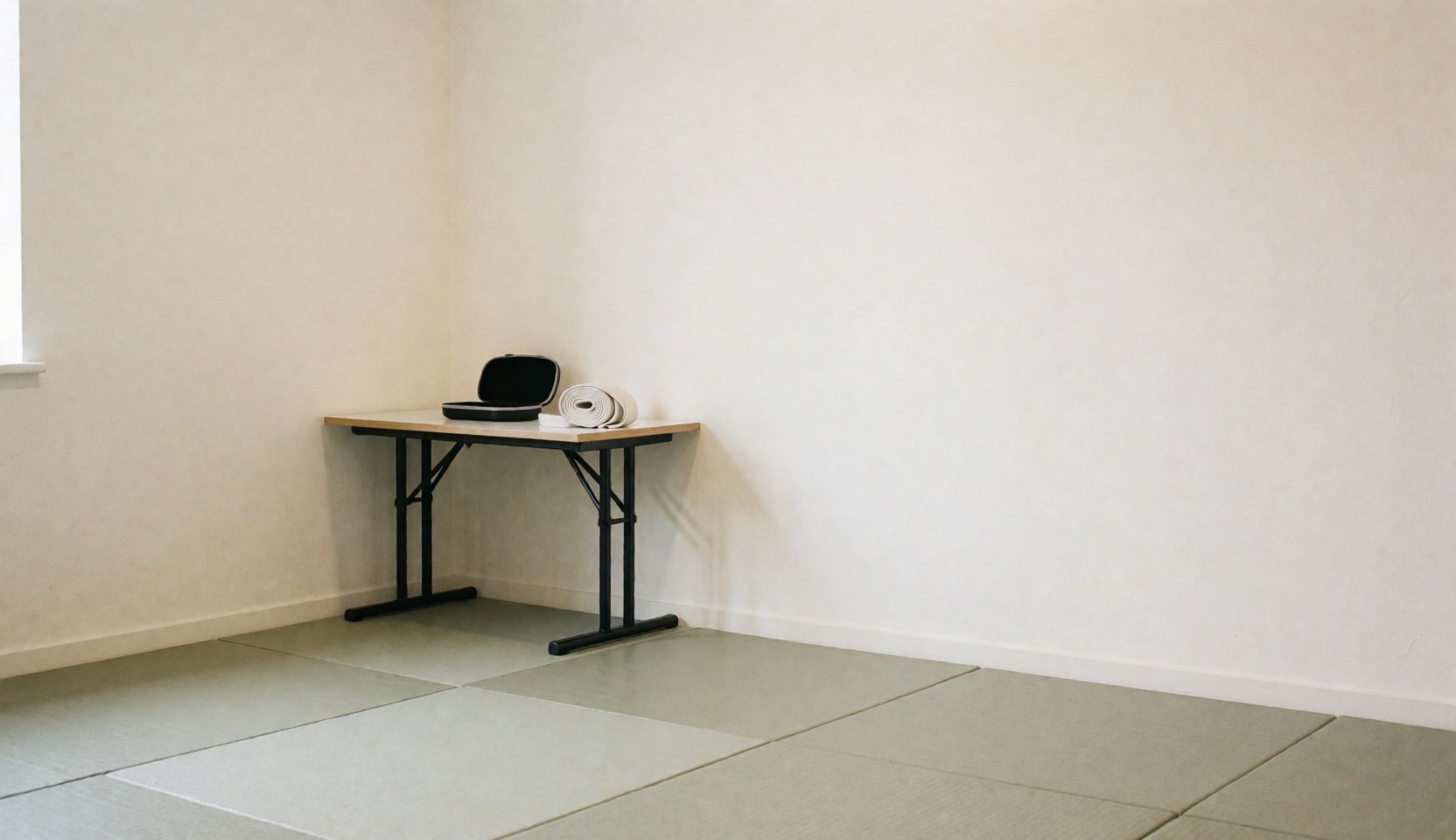 Karate equipment including a mouthguard and gi belt on a wooden table in a dojo with tatami mats and cream walls