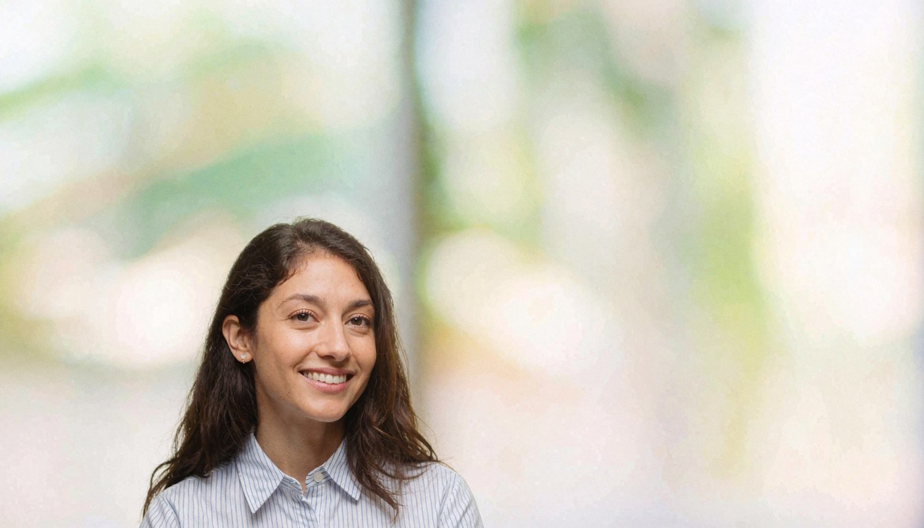 Smiling professional woman in office with blurred background, ideal for business covers