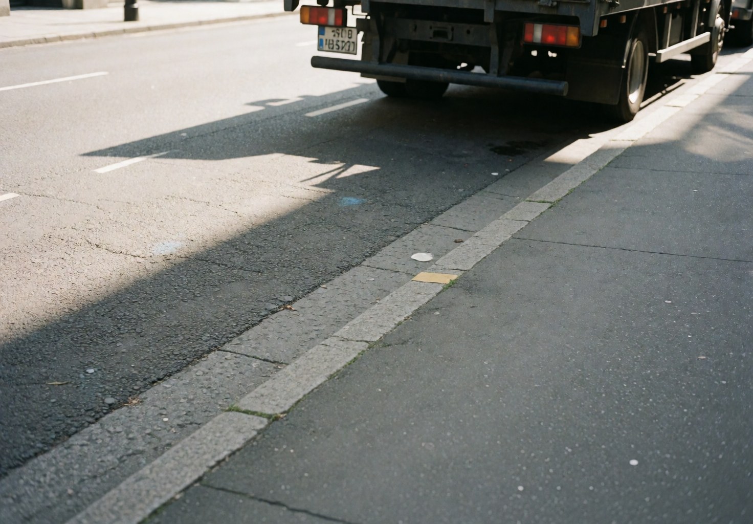 Marketing truck parked on street with shade and space for customers, ideal for street food business.