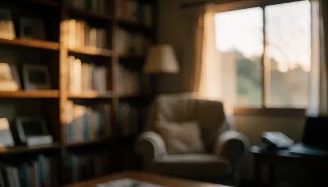 Blurred background of a rural living room with an armchair, bookshelf, and warm sunset light, ideal for accommodation text overlays