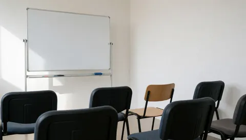 Empty writing room featuring chairs and a whiteboard, suitable for a writing school website cover.