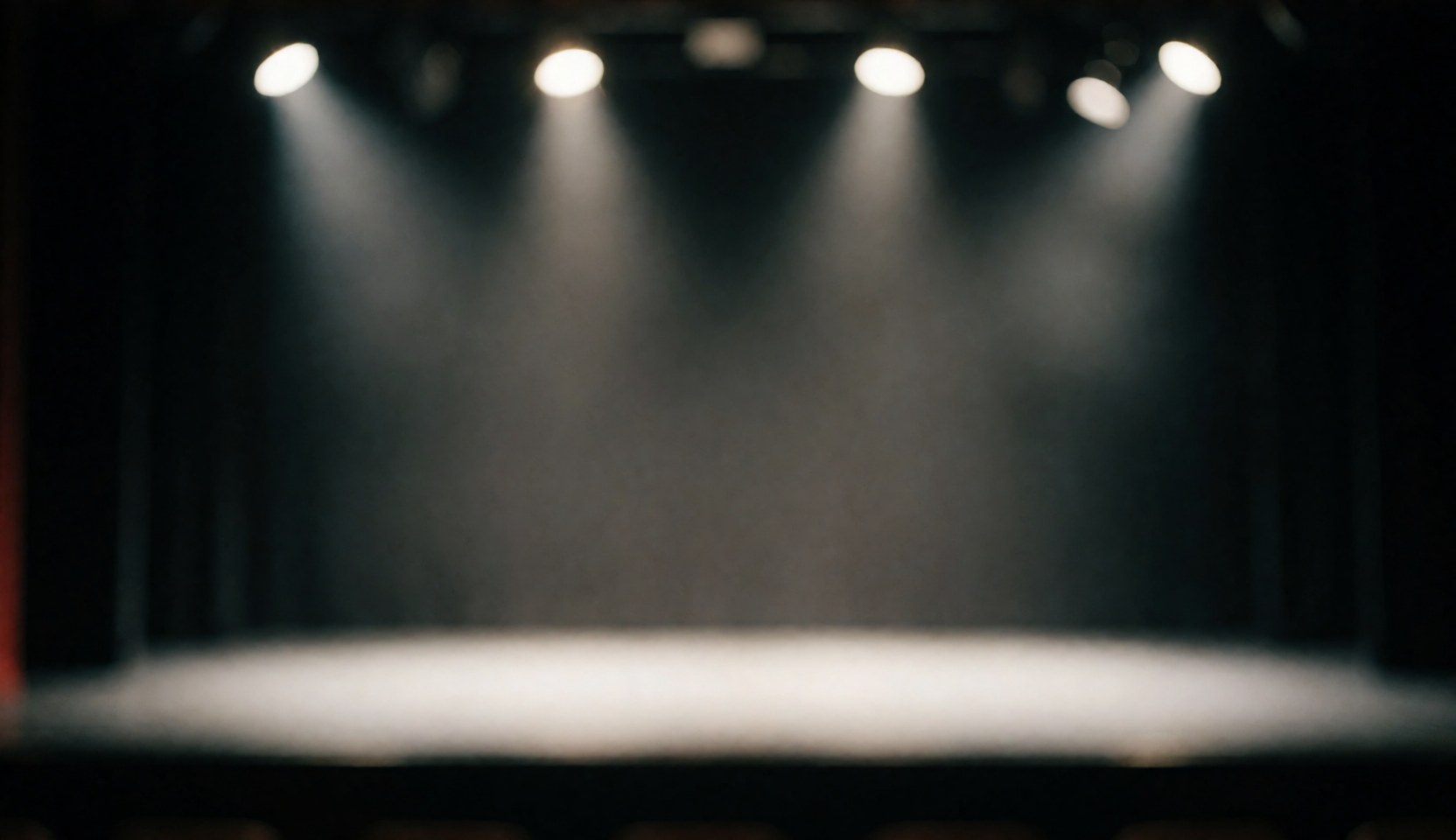 Empty dance stage floor illuminated by dramatic stage lights against a dark background, creating a professional atmosphere suitable for text overlays.