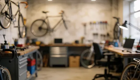 Bicycles hanging in a bike workshop with tools on workbenches, ideal for text backgrounds