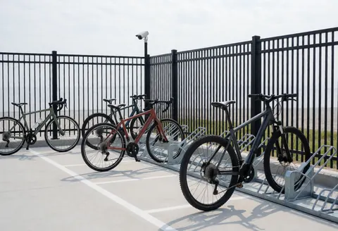 Metal bicycle parking rack with concrete floor and security camera for cycling instructors
