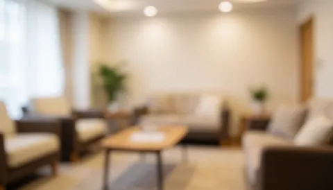 Soft focus background of a cozy waiting area with comfortable seating and warm lighting, suitable for dance school text overlays