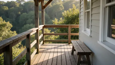 Wooden deck with bench, gray walls, and forest view, ideal for ecological park website hero section