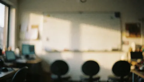 Circular chairs arranged in a writing workshop with a whiteboard and warm sunset light, ideal for text backgrounds.