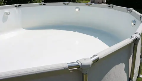 Empty above ground swimming pool featuring a stainless steel frame and underwater lighting, suitable for pool installation projects.