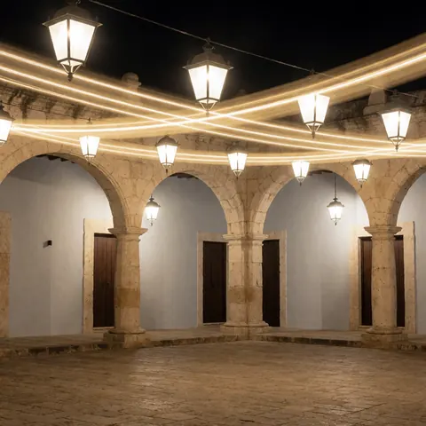 Stone arches and illuminated lanterns in a colonial plaza at night, ideal for business backgrounds
