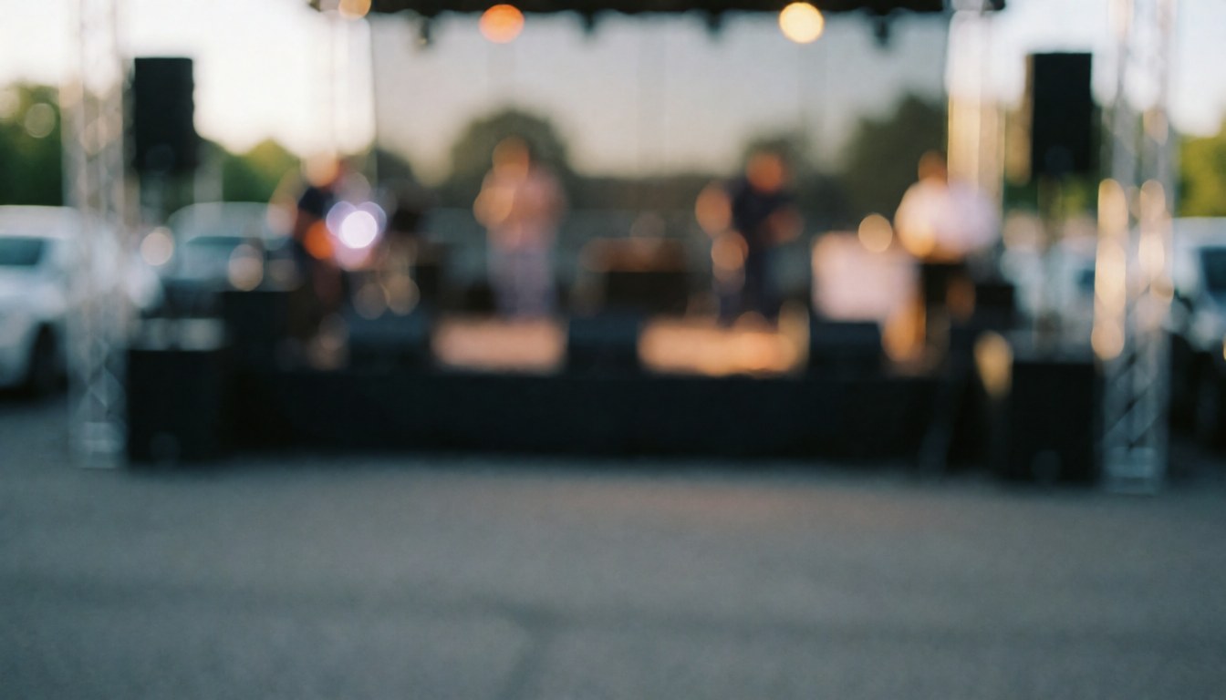Outdoor party stage with lights and speakers, blurred background for text.