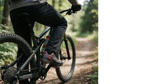 Close-up view of cycling shoes with cleats attached to mountain bike pedals on a forest trail