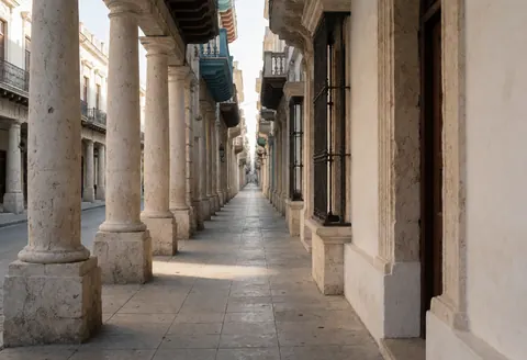 Narrow colonial street featuring stone columns, clean pavement, and historic architecture in a pedestrian area, suitable for bicycle taxi storefronts.