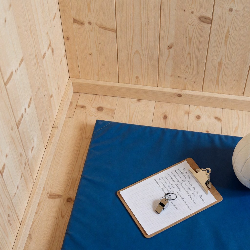 Volleyball coach portfolio featuring a whiteboard, whistle, and ball on a blue court with wooden walls