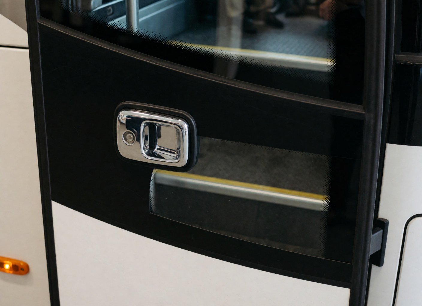 Detailed view of a chrome bus door handle and yellow step, highlighting industrial design and material quality for public transport vehicles.
