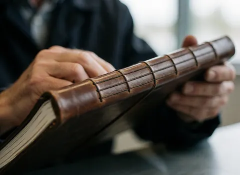 Detailed view of a leather-bound journal showing professional stitching and texture, suitable for hypnotherapy business branding.
