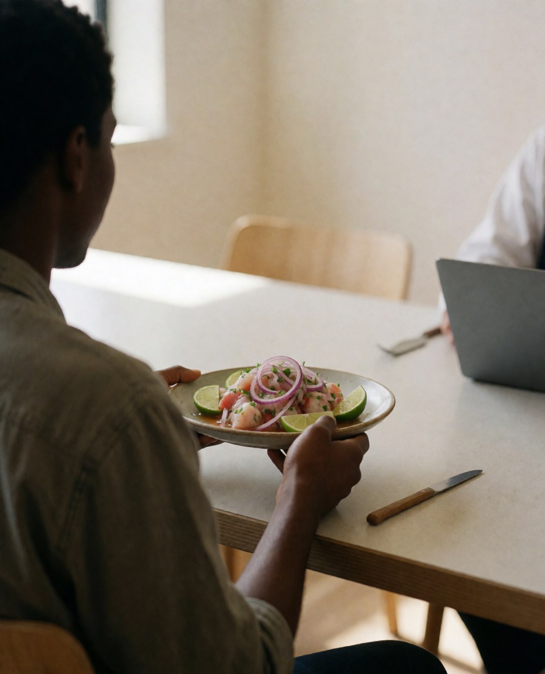 A happy customer enjoying fresh ceviche in a bright restaurant with light walls and natural lighting, representing a positive dining experience for cooking classes.