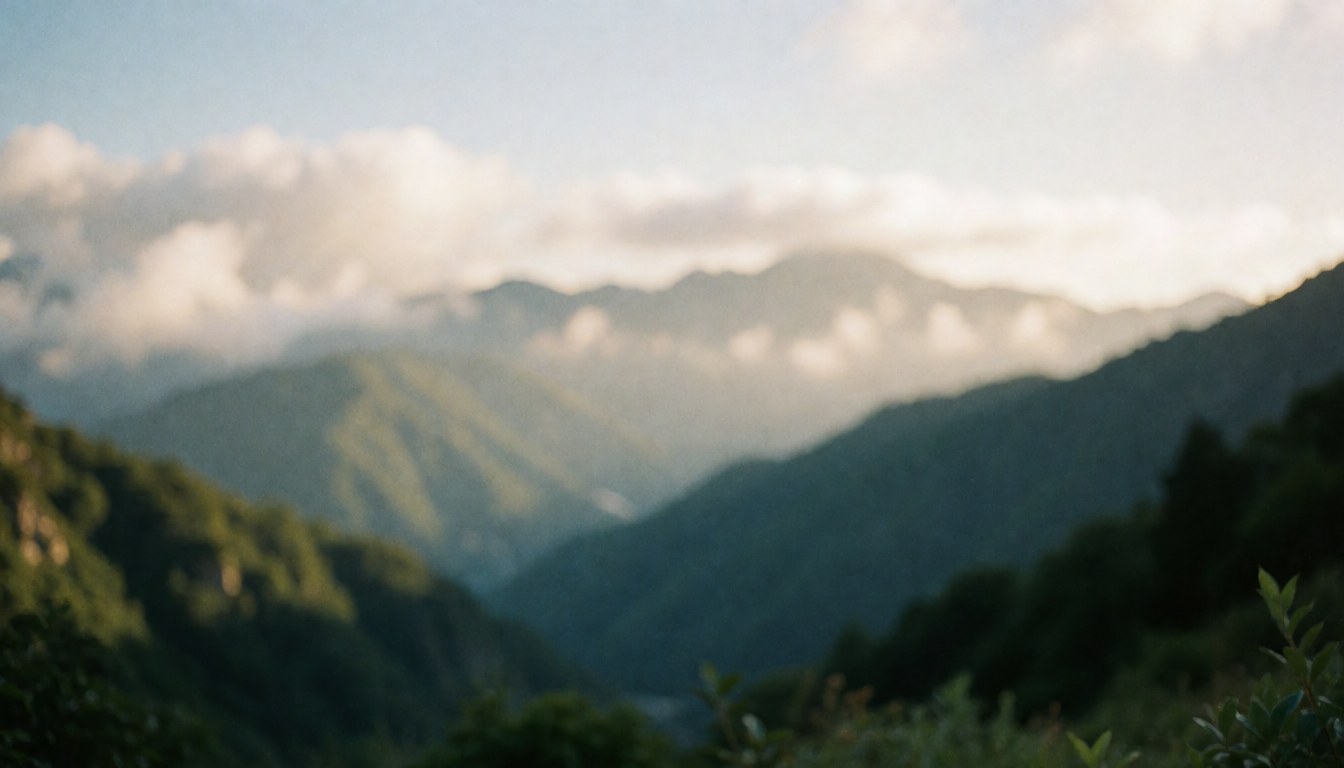 Serene mountain landscape with clouds and warm light, ideal background for mountain bike coach text