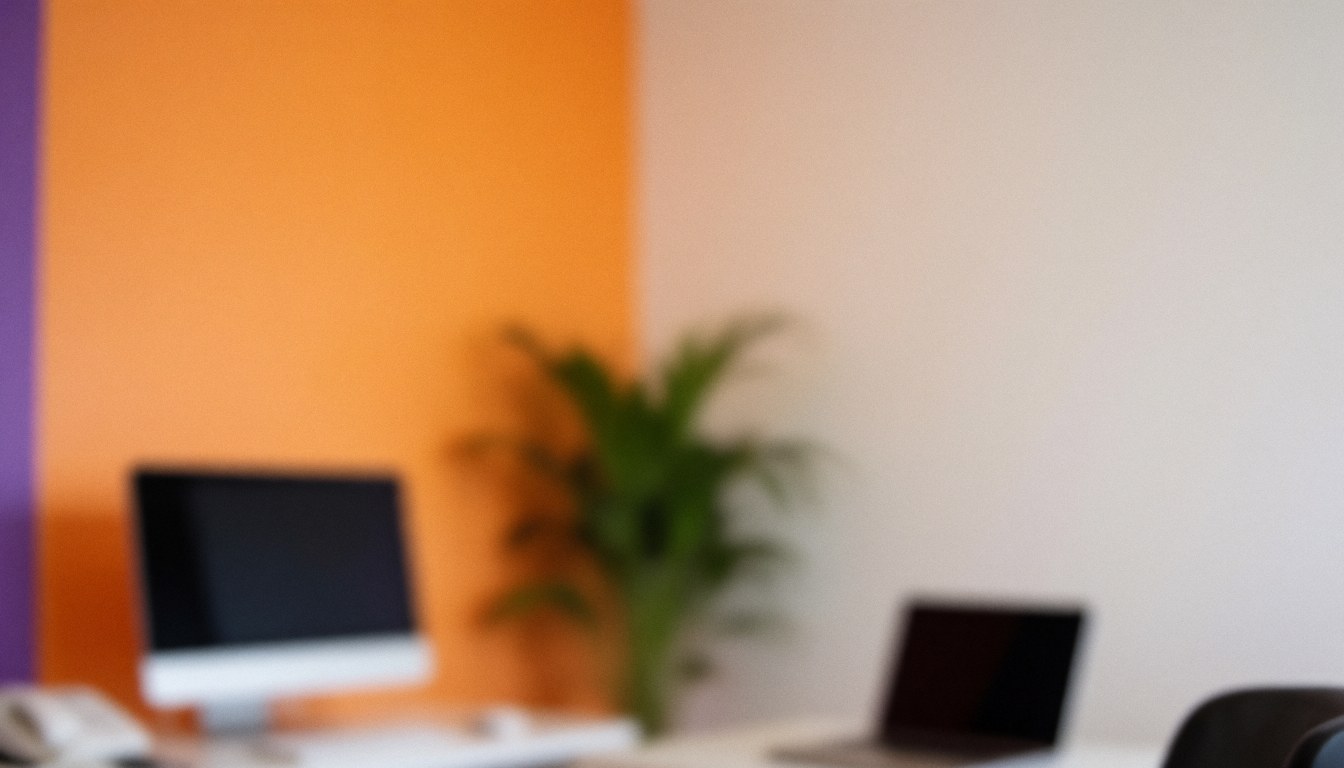 Office background featuring orange and purple walls, a computer, laptop, and plant, ideal for text overlays