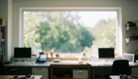 Office background with natural light, blurred greenery outside the window, desks and chairs, suitable for writing text overlays.