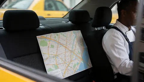 A city map placed on the back seat of a taxi, illustrating a realistic scene for taxi service operations.