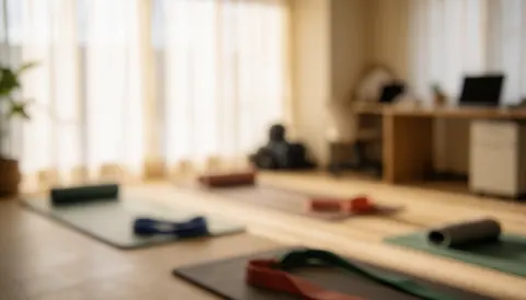 Yoga mats and resistance bands arranged in a stretching room with soft lighting and a calm atmosphere for physical recovery