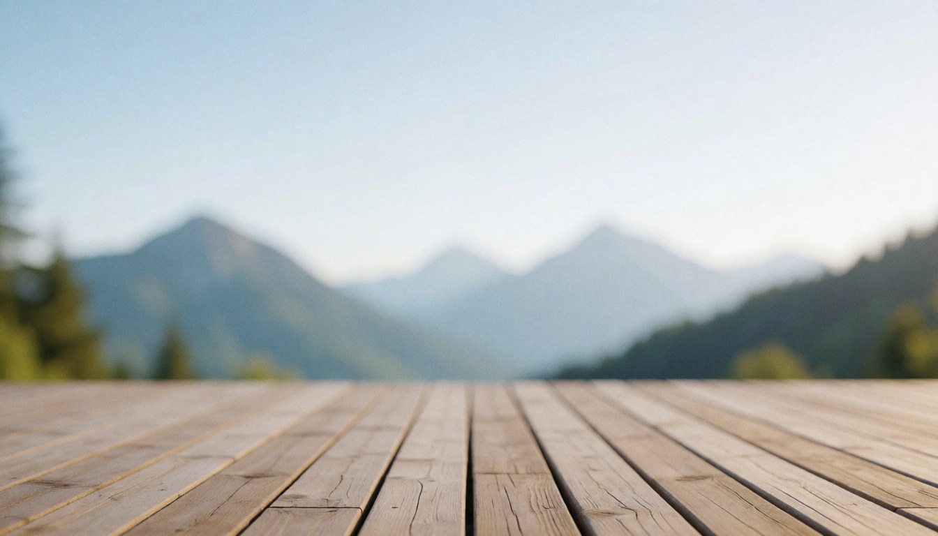 A wooden terrace deck with blurred mountains in the background, ideal for text overlays or mountain shelter advertisements