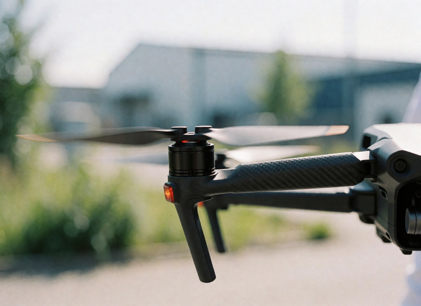 Detailed view of a drone with rotating propellers in an industrial setting, highlighting aerial photography technology.