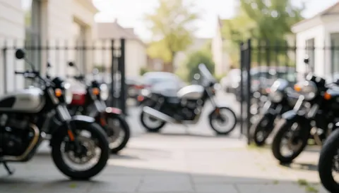Close-up view of motorcycle engines placed on pavement in a parking area with metal fencing, suitable for commercial text backgrounds.