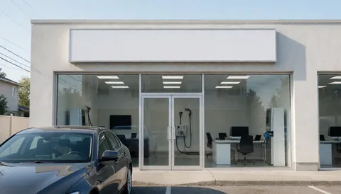 Exterior view of a clean car wash building featuring glass doors and ample space for text overlay near the entrance.