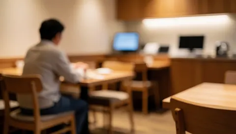 A customer sitting in a restaurant with wooden tables and chairs, warm lighting, and a cozy atmosphere suitable for text overlay.
