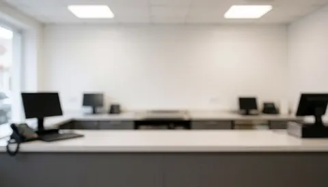 Clean butcher shop counter background with monitors and cash register, ideal for commercial text overlay