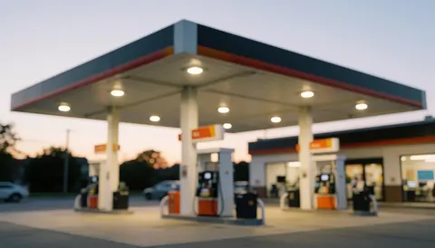 Modern gas station with roof and pumps, soft blurred background, ideal for advertising text.