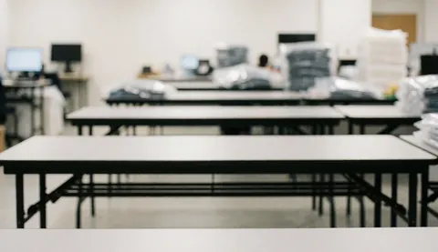Industrial background featuring foldable tables and stacks of plastic bags, suitable for textile manufacturing text overlays.